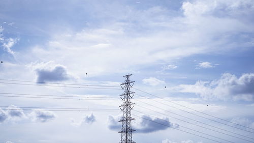 Low angle view of electricity pylon against sky