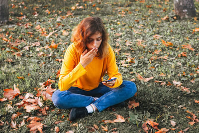 Young woman sitting on field