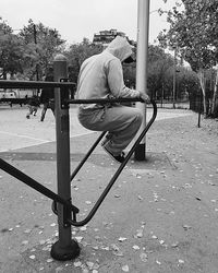 People enjoying swing in playground