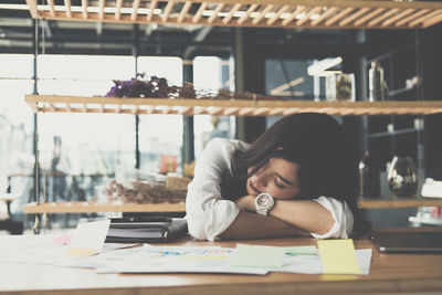 Businesswoman napping at desk in office