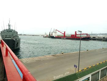 Ship moored at harbor against clear sky