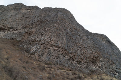 Low angle view of rock formation against clear sky