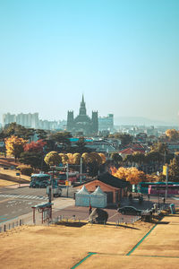 Buildings in city against clear sky