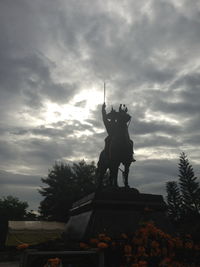 Low angle view of statue against cloudy sky