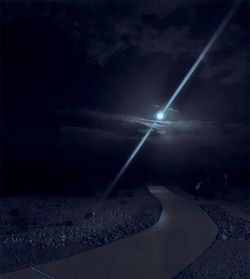 View of illuminated street against sky at night