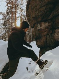 Man standing on rock in snow. altai, belokuriha