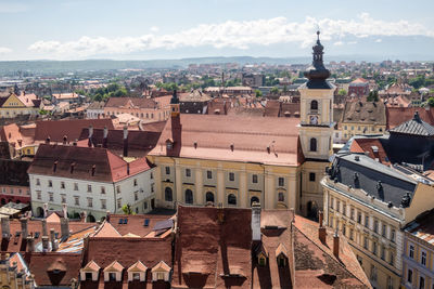 Aerial view of buildings in town against sky