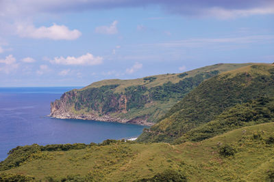 Scenic view of sea and mountains against sky