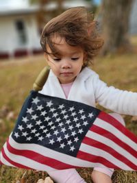 Portrait of girl holding american flag
