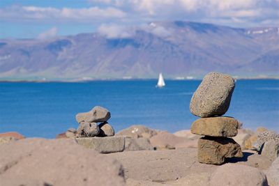 Rocks on beach against sky