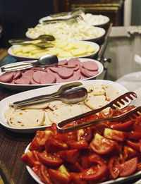 Raw vegetables slices in plates on kitchen counter at home