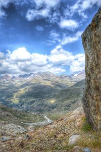 Scenic view of mountains against cloudy sky