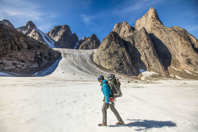 Backpacker hiking on glacier through akshayak pass, baffin island.