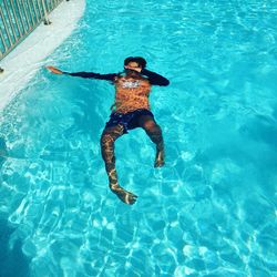 High angle view of boy swimming in pool