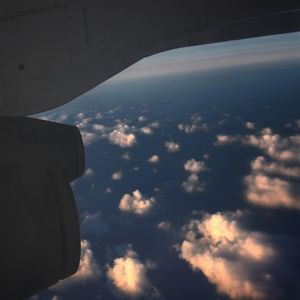 Airplane wing against sky