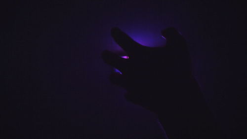 Silhouette of man against dark sky