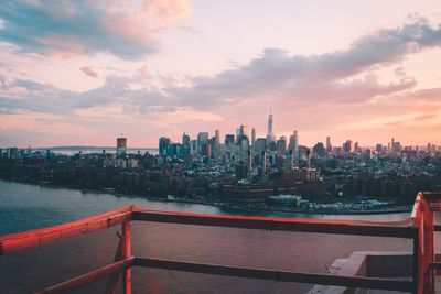 View of cityscape against cloudy sky