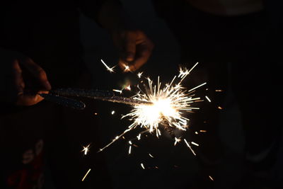 Low angle view of fireworks exploding in the dark