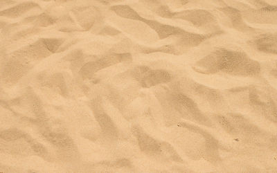 Full frame shot of paper on sand