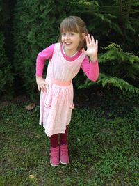 Portrait of smiling girl standing on pink flower