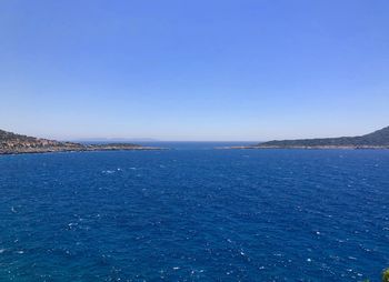 Scenic view of sea against clear blue sky