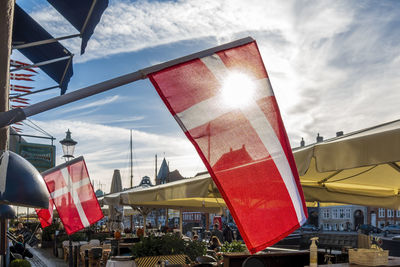 Low angle view of flag against buildings in city