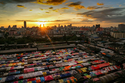 Aerial view of buildings in city during sunset