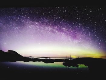 Scenic view of silhouette mountains against sky at night