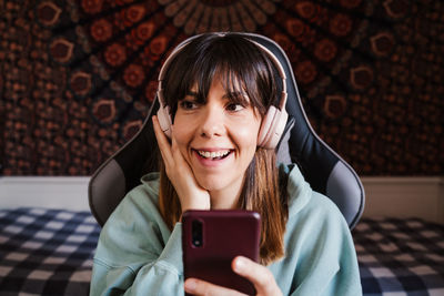 Cheerful woman talking on video call at home