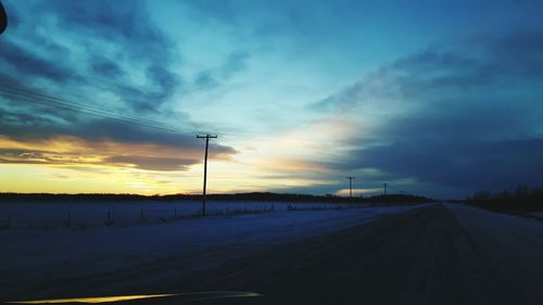 Electricity pylon against sky during sunset