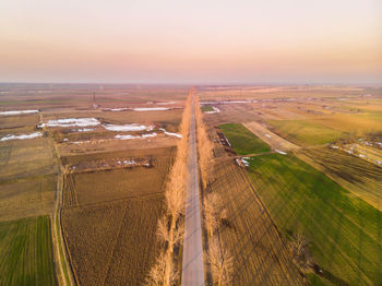 High angle view of agricultural field against sky during sunset