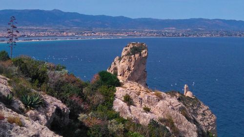 High angle view of rocks on sea shore against sky