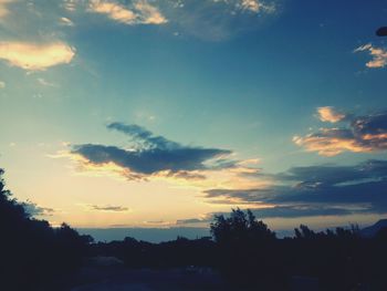 Silhouette trees against sky during sunset