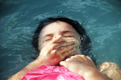 High angle portrait of woman/girl  swimming in pool