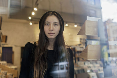 Portrait of a young woman through a window