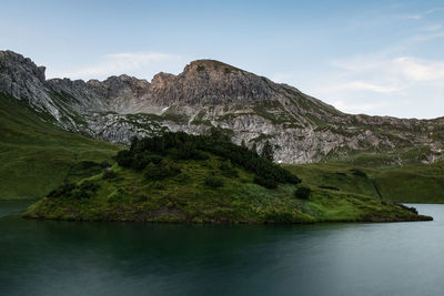 Scenic view of lake and mountains against sky