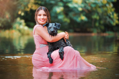 Woman with dog in lake