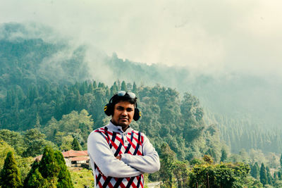 Portrait of man standing against mountain