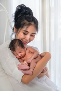 Close-up of mother and daughter at home