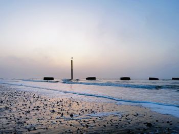 Scenic view of beach against sky during sunset