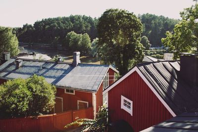 High angle view of houses and trees by building against sky