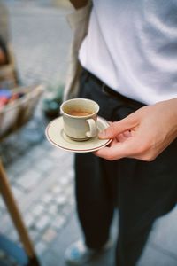 Midsection of man using mobile phone
