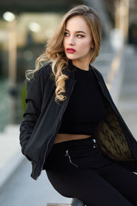 Beautiful young woman standing in city