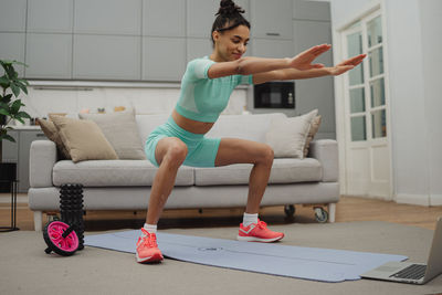 Portrait of young woman exercising in gym