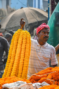 Full length of man for sale at market stall