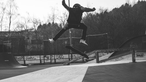 Full length of man skateboarding at skateboard park