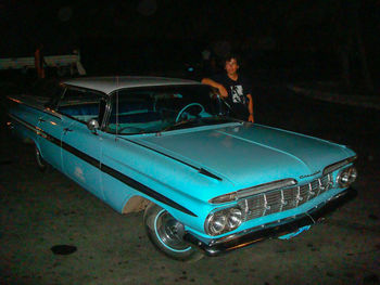 Rear view of man with toy car at night