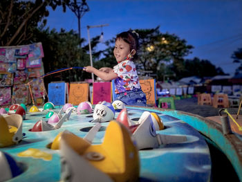 Cute girl playing with toy in playground