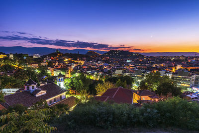 High angle view of illuminated buildings against sky at sunset