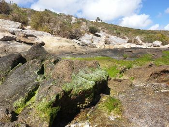 Rock formations on landscape against sky